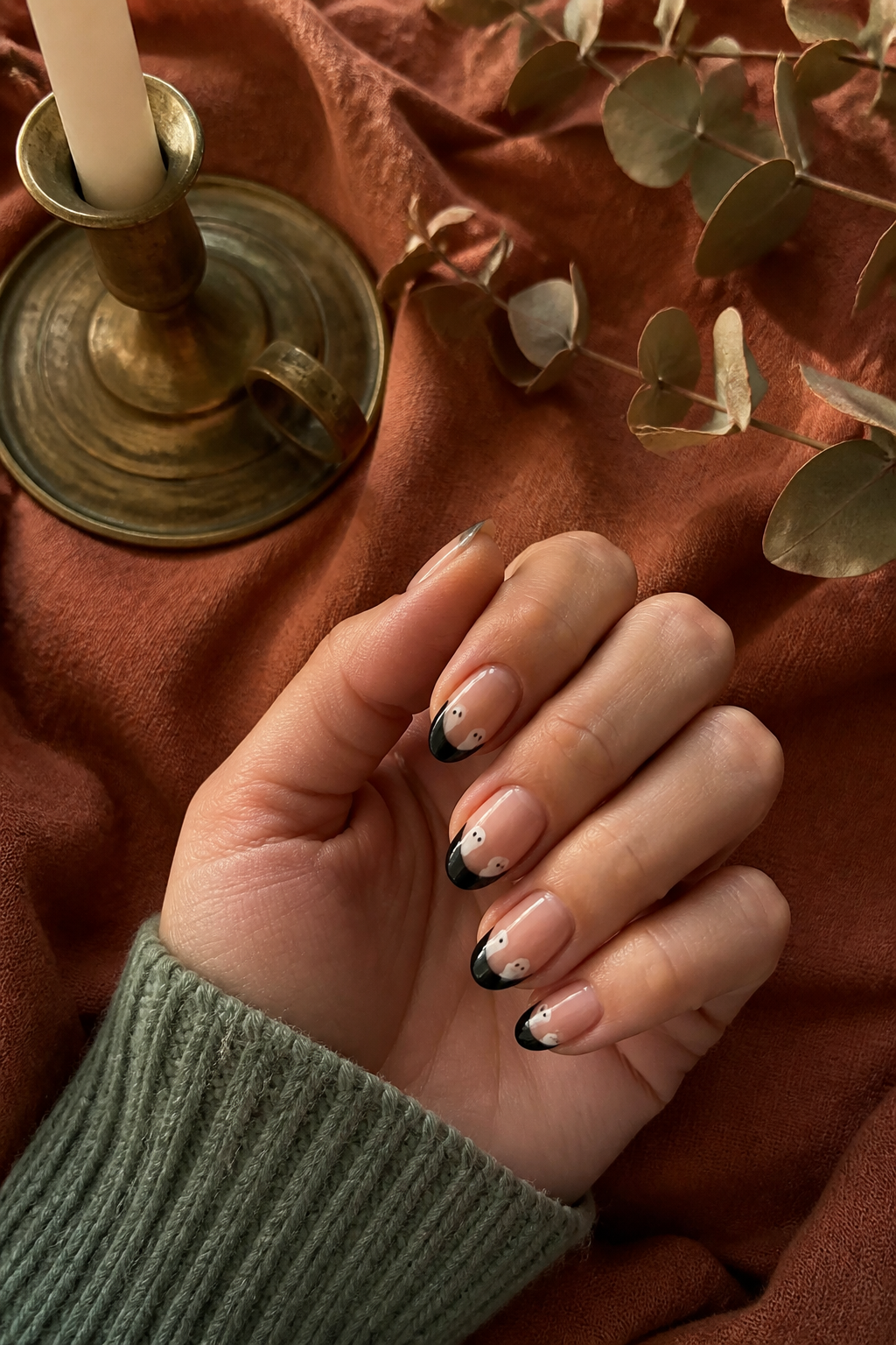 Black French Ghosts ghost manicure shown from a distinct editorial hand pose